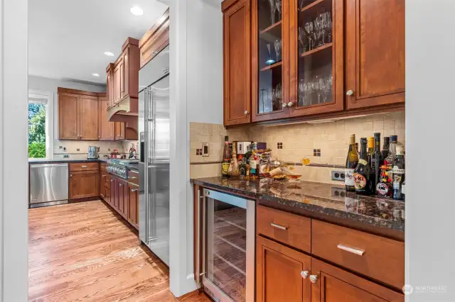 Walk-in pantry & serving station with wine fridge.