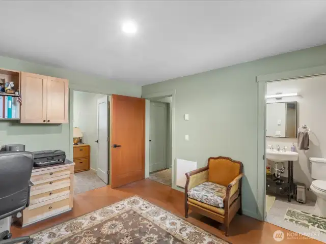 Den/Office/Guest room showing ensuite to right, hallway center, extra finished room thru door to left.