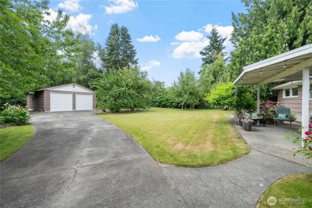 Spacious backyard with a covered patio, lush lawn, and easy access to the 24' x 32' detached garage.