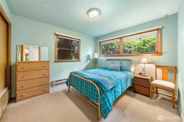 Bedroom with soft blue custom walls and abundant natural light!