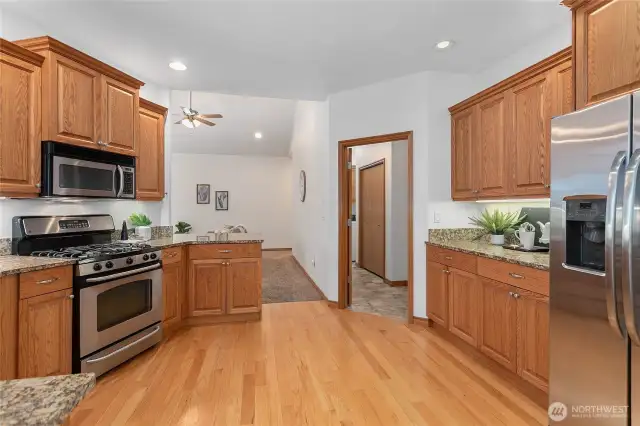 Kitchen leads to generous walk-in utility room and attached garage