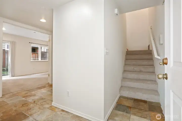 From the front door, the first bedroom is to the left.  Nice stone flooring.