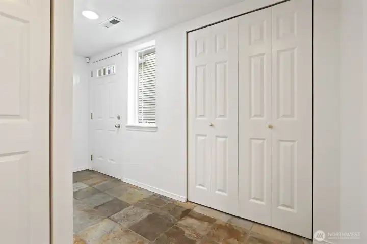 Looking back to the front door.  There is a linen closet to the right of the window. To the left is a full bath and washer/dryer.