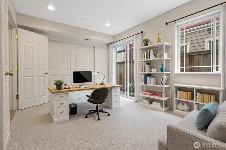 The lower level bedroom has a large closet and glass sliders to a small patio and yard.