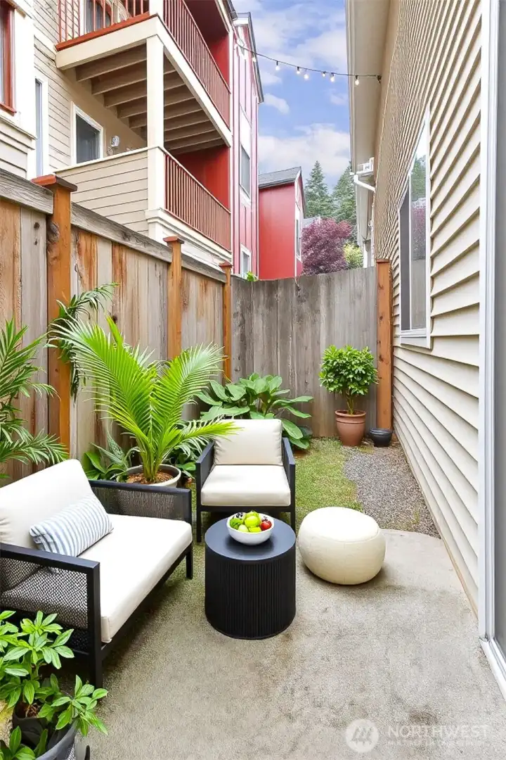 Small patio and yard outside the lower level bedroom.  Fully fenced.