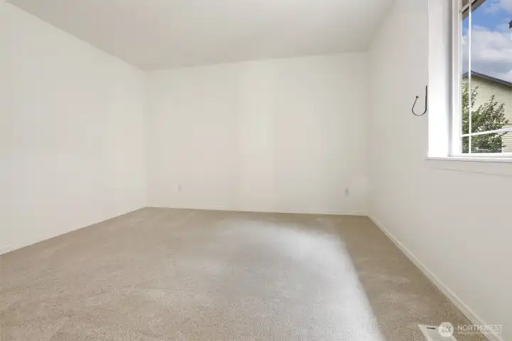 No virtual staging in the primary bedroom. New carpet!
