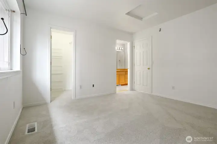 The primary bedroom has a walk-in closet and access to a full bathroom.  New carpet in this room.