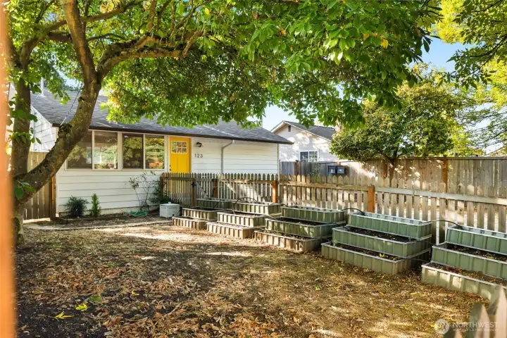 123 MLK Front house - front yard is fenced, with garden beds