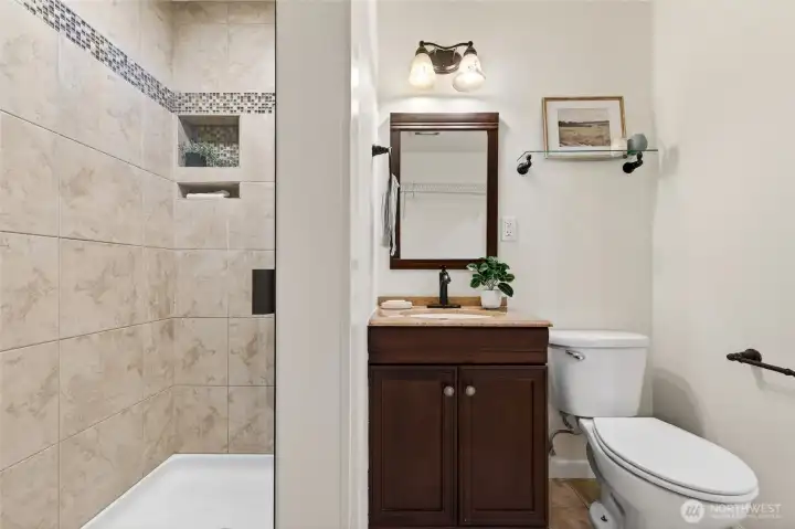 Downstairs bathoom/laundry room includes shower