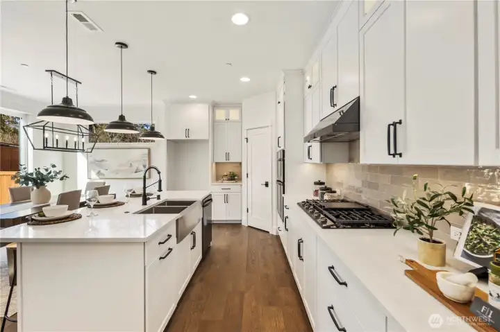 Kitchen Workspace:  This well-appointed kitchen features full-height shaker cabinetry, sleek quartz counters, and a modern tile backsplash that adds texture and warmth. The layout maximizes storage and prep space, keeping everything within easy reach while maintaining a streamlined aesthetic. As part of Bothell’s Canyon Park community, the home benefits from nearby parks, dining, and transit options that support a balanced Pacific Northwest lifestyle. Thoughtful lighting, upgraded appliances, and polished finishes elevate the space for both everyday cooking and more ambitious culinary projects.    These photos are from Lot 5 at Gooden Hollow, the home listed here. However, other homes in the community will have changes, so all photos, renderings, site maps, and floorplans are for visualization purposes only. Plans, colors, building orientation, finishes, home outlook, and other details can and WILL vary.