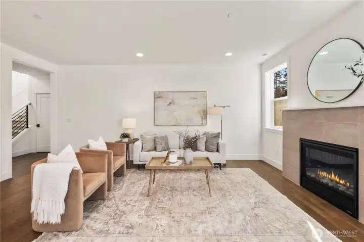 Main Living Overview:  Wide sightlines connect the kitchen, dining area, and great room, emphasizing natural light from multiple windows and the warm tones of the engineered hardwoods. This open-concept layout offers exceptional flexibility for furniture placement and comfortable living. Located in Bothell’s Canyon Park area, the home provides quick access to shopping, Northshore schools, and major commuting routes, making day-to-day life both convenient and connected. The scale of the space lends itself beautifully to hosting, creating room for gatherings of all types while maintaining a clean, modern aesthetic.    These photos are from Lot 5 at Gooden Hollow, the home listed here. However, other homes in the community will have changes, so all photos, renderings, site maps, and floorplans are for visualization purposes only. Plans, colors, building orientation, finishes, home outlook, and other details can and WILL vary.