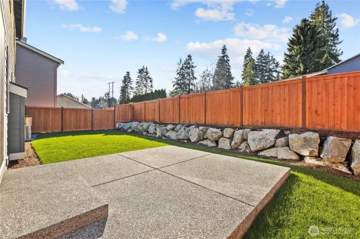 Backyard:  The fully fenced backyard offers a wide lawn, handsome rockery, and a sense of privacy enhanced by mature evergreens beyond the fence line. With plenty of level space, it’s ideal for outdoor relaxation, gatherings, or quiet moments at home. Located in the heart of Bothell near Canyon Park and local trail systems, this yard captures the best of Pacific Northwest outdoor living. The large patio extends the home’s usable space, perfect for dining, grilling, or year-round enjoyment.    These photos are from Lot 5 at Gooden Hollow, the home listed here. However, other homes in the community will have changes, so all photos, renderings, site maps, and floorplans are for visualization purposes only. Plans, colors, building orientation, finishes, home outlook, and other details can and WILL vary.