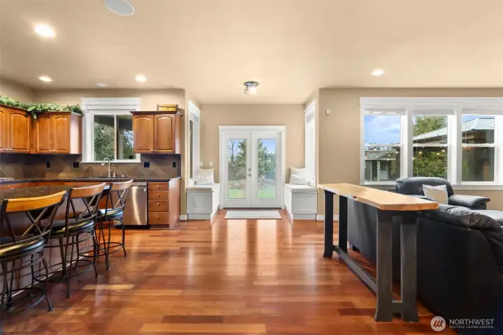 Off the open concept kitchen, there are French doors that lead to a gorgeous backyard. This design enhances the connection between the indoor living space and the outdoor area, creating an inviting and spacious environment. The French doors allow for ample natural light and fresh air, making the kitchen feel even more expansive. The beautiful backyard provides a stunning backdrop and an ideal spot for outdoor enjoyment, whether it's entertaining guests, relaxing, or simply appreciating nature.