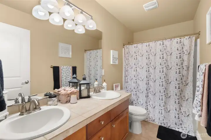 Full second-level bathroom with tile finishes.