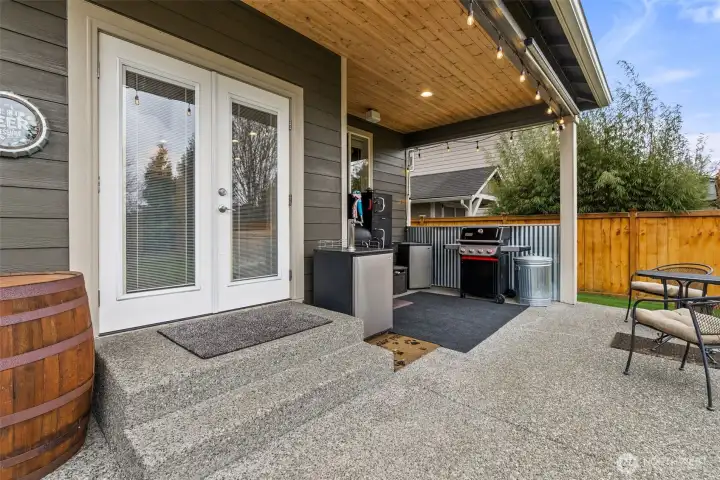 Outdoor entertaining space featuring a covered patio, pine ceiling detail, speakers, and gas-plumbed BBQ.