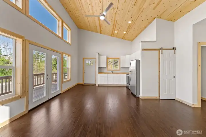Bright, open and cozy living space! Pine ceilings are a nice contrast to the clean, light interior.
