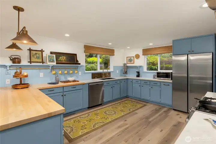 Charming details in spacious kitchen featuring stainless appliances and ample cabinetry