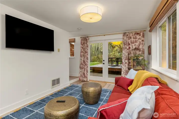 French doors lead to a patio with deck for garden entertaining