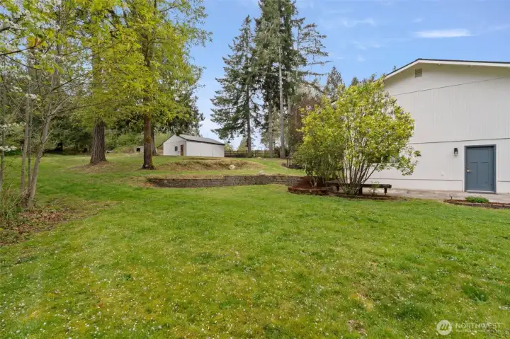 Side yard with open space to spread out, play, garden, or simply enjoy the side patio.