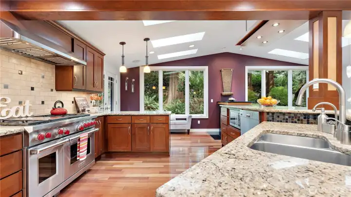 This kitchen was designed to do more than simply look impressive, with rich wood cabinetry, expansive granite counters, a pro-style range, and skylights pouring light across the entire space. And straight ahead, the trees become part of the experience too, bringing that lovely Northwest connection right into the heart of the home. This kitchen was designed to do more than simply look impressive, with rich wood cabinetry, expansive granite counters, a pro-style range, and skylights pouring light across the entire space. And straight ahead, the trees become part of the experience too, bringing that lovely Northwest connection right into the heart of the home.