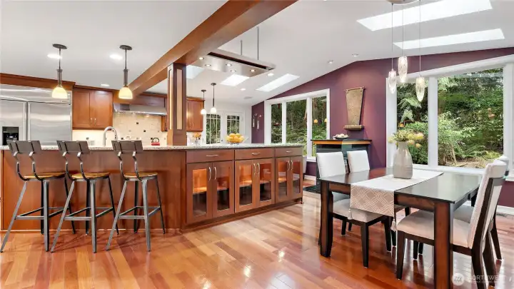 This portion of the home was expanded to create a stunning Norsk-modeled kitchen, where contrasting natural materials, clean lines, and smart storage come together beautifully. The lighted cabinetry below is such a gorgeous detail.