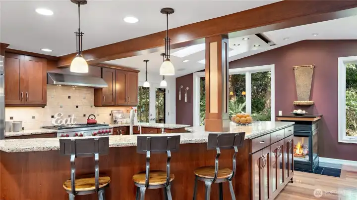 It’s easy to notice the breakfast bar, but don’t miss the contrasting wood detail on the pillar or the water feature above the fireplace, both adding richness and visual interest to the space. And yes, that water feature is easily controlled with a wall switch.