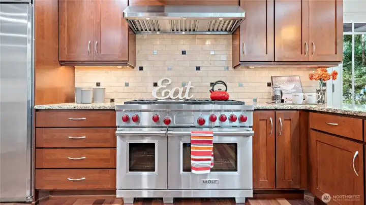 And then there’s the 48-inch dual-fuel Wolf range with dual convection ovens and a griddle... a standout centerpiece for a kitchen that was clearly designed with both beauty and serious cooking in mind.