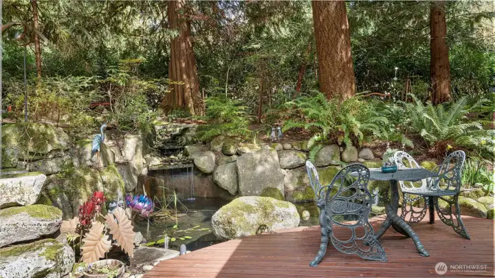 The waterfall tumbles into a pond with three large koi, while a second pond rests above. It’s a wonderfully layered design that brings movement, sound, and such a calming presence to the garden.