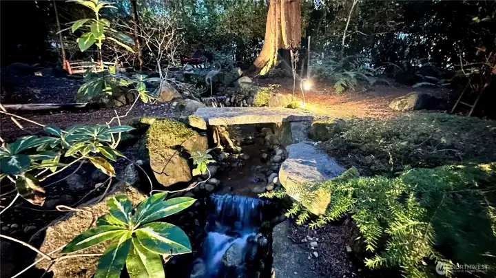 This stone bridge sits just above another tier of the waterfall, and the sound of the water here is absolutely captivating... steady, soothing, and woven beautifully into the whole experience.