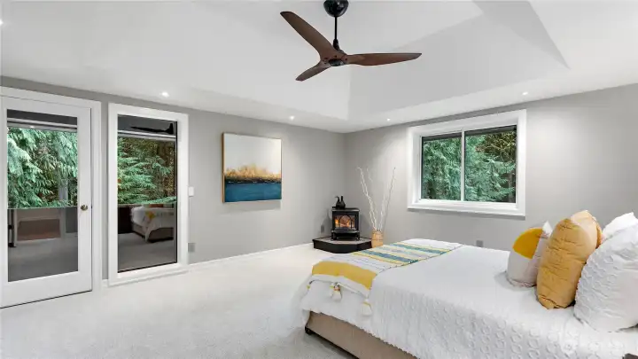 Upstairs, the owner’s suite is generous in scale and rich in comfort, with a private balcony, freestanding gas fireplace, and a high-end ceiling fan that gives the room an added sense of polish.