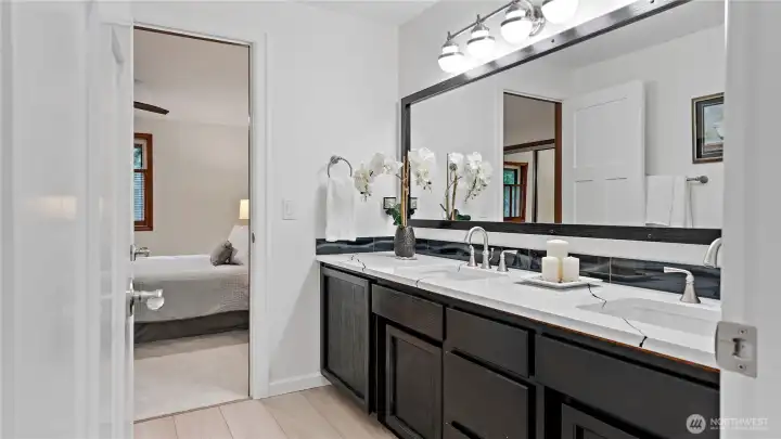 Between the two bedrooms, you’ll find a nicely updated Jack and Jill bath with a large dual-sink vanity and plenty of room to get ready without crowding each other. It’s such a functional setup, and so well done.