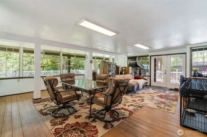 Spacious sunroom with french doors out to the backyard.