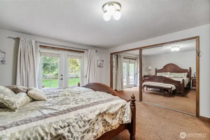 Another view of the primary bedroom.  Huge closet and french doors that lead out to the backyard.  The perfect place to unwind and get rest.