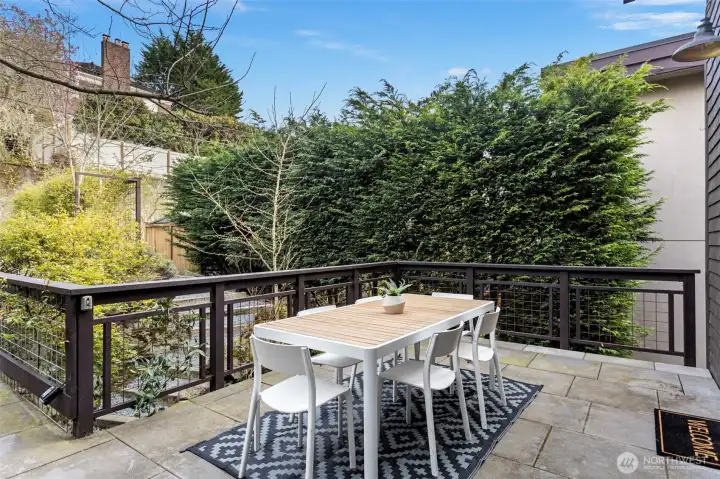 Spacious private deck connects to alley off street parking area and leads to kitchen / dining areas (upper level 2)