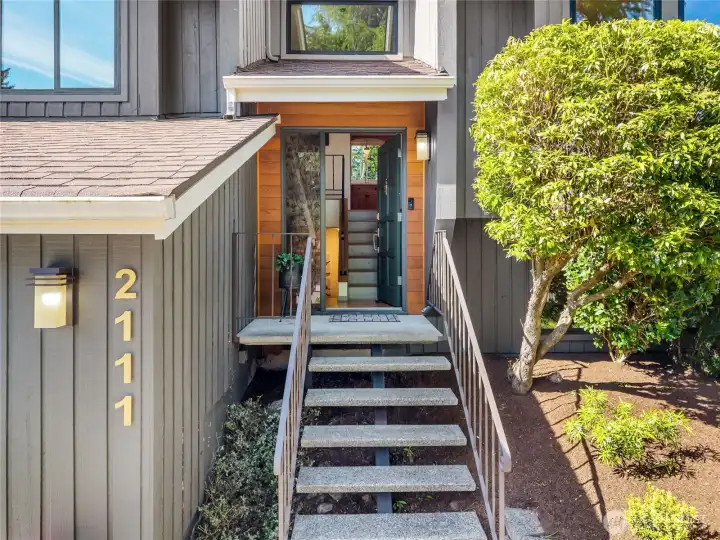 Inviting front porch with floating concrete steps.