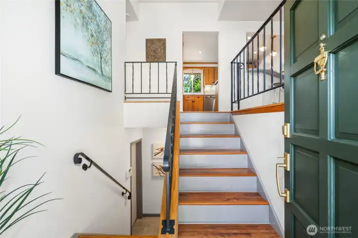 Light and bright entryway into the home with lovely forrest green painted door.