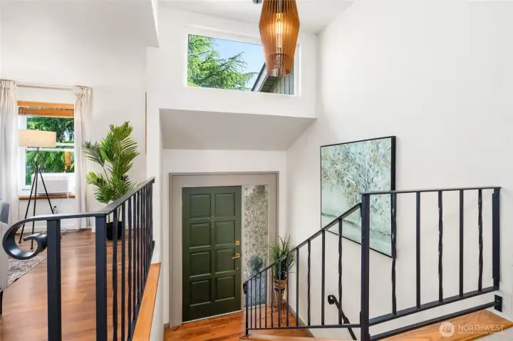 Looking down to the entryway, with custom light fixture.