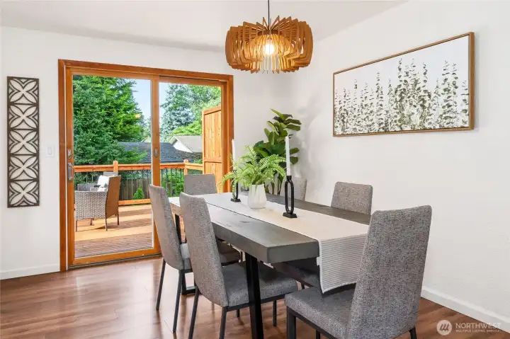 Dining room with custom light fixture leads out to the expansive deck.