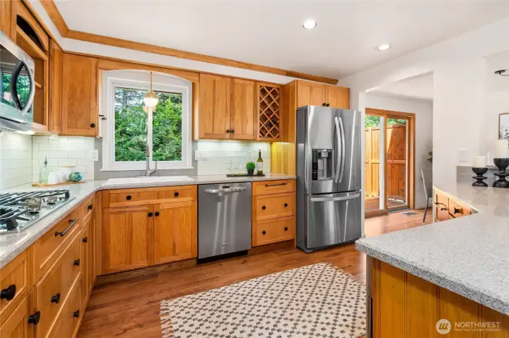 A look into the chef's kitchen with stainless steel appliances.