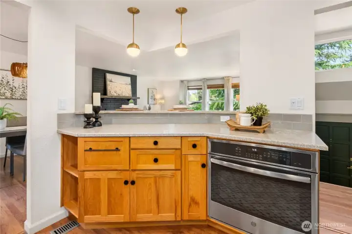 Built-in oven and view looking out toward living room.