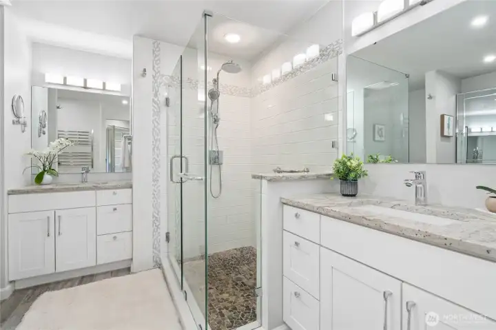 Amazingly large primary bath with split dual vanities and granite countertops.