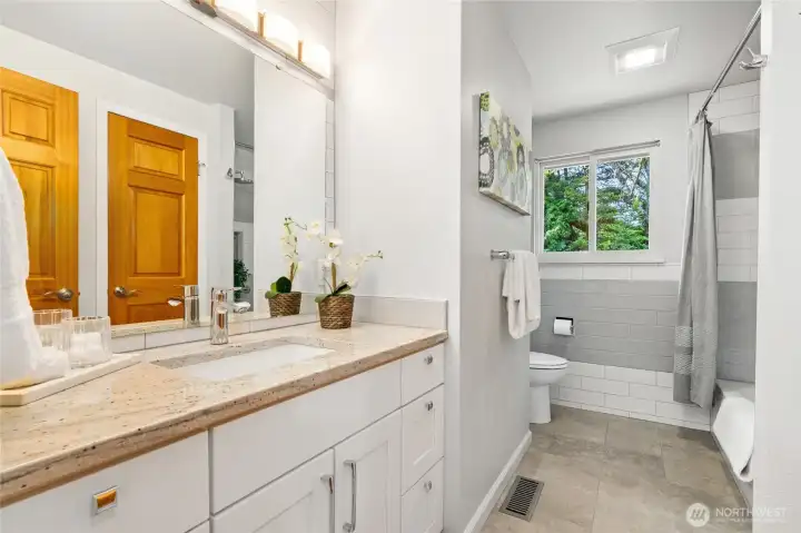 Main floor bathroom with tile flooring.