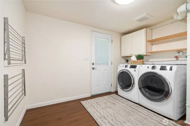 Large lower level utility room with access to the back yard.