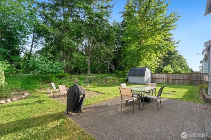 Large backyard with storage shed and firepit Large backyard with storage shed and firepit
