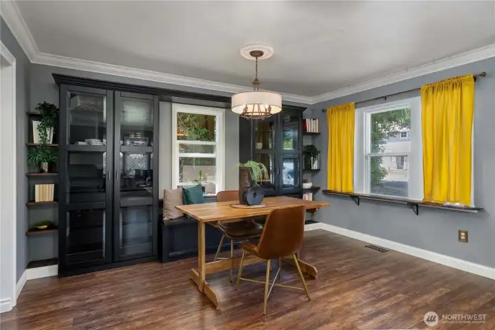 Dining area with custom bookcases and window seat. Dining area with custom bookcases and window seat.
