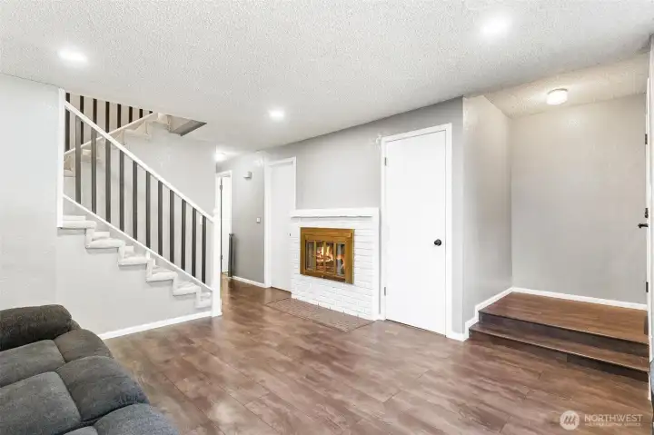 Living room space accompanied by cozy fireplace