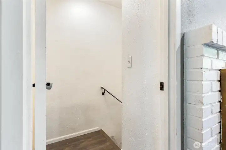 Leading down to first floor flex room and 1-car garage