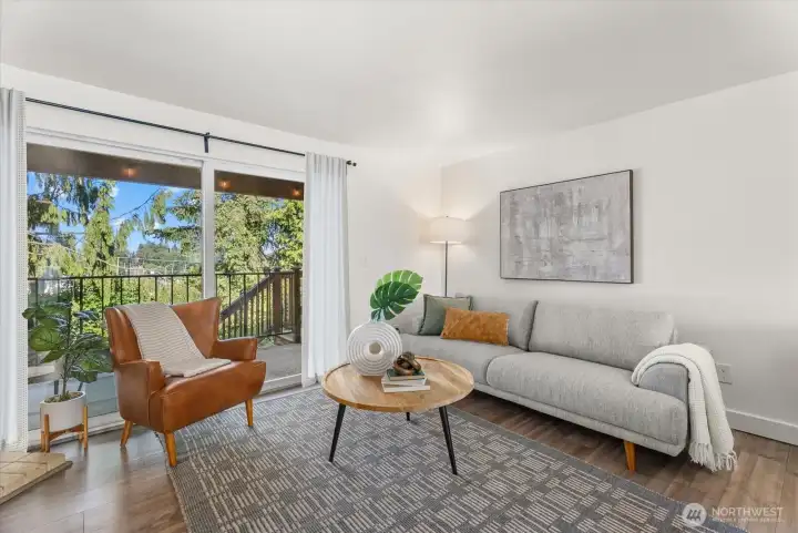 Spacious and bright living room opening up to a large balcony and backyard.