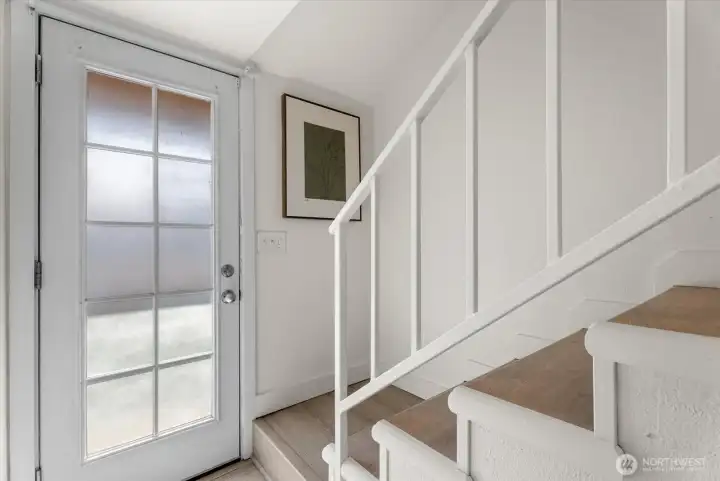 Staircase and door to front balcony.