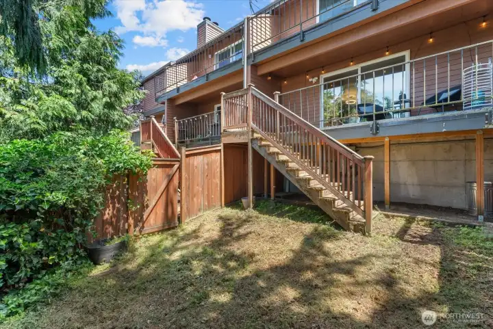Private, fully fenced backyard with additional storage below the balcony.